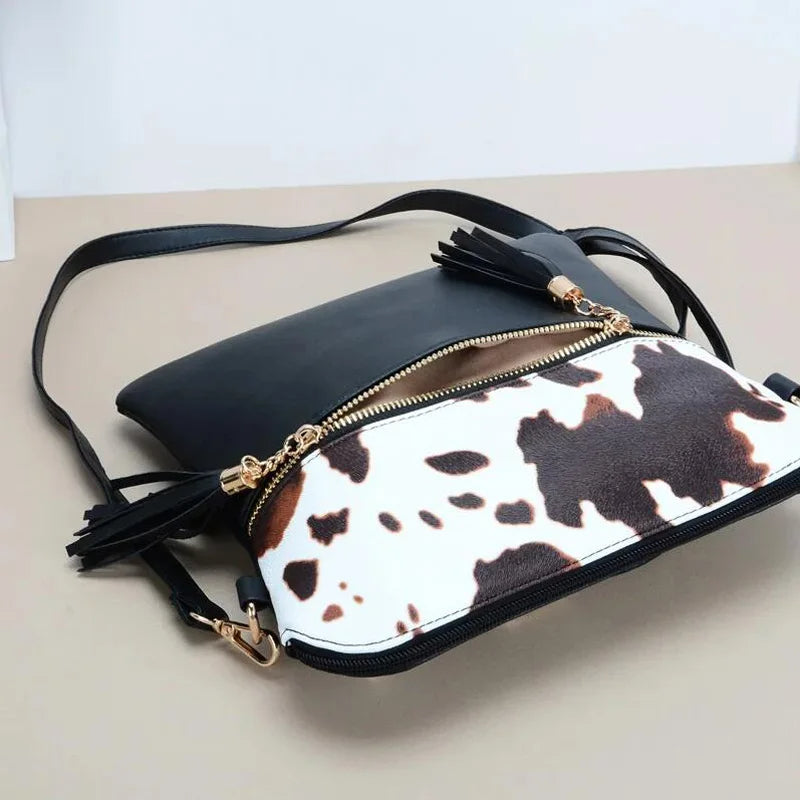 Trinity - koeienprint crossbody tas met kwastjes